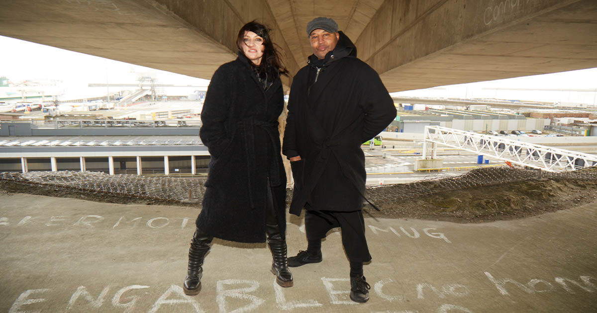 Two musicians standing overlooking the Port of Dover.