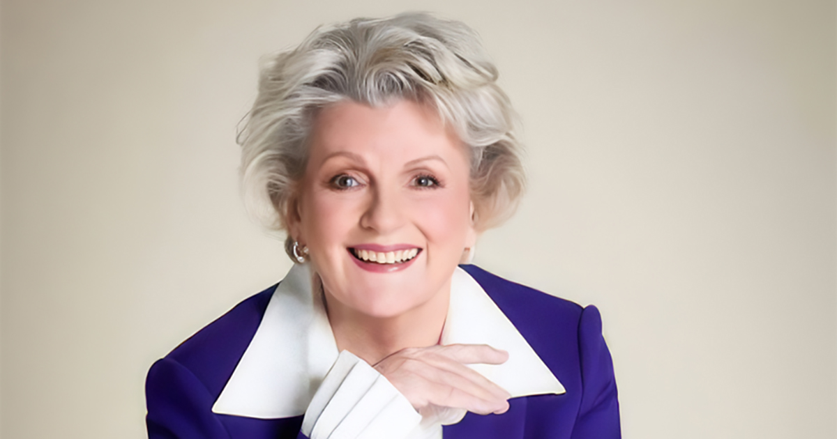 Brenda Blethyn smiling, with her hands resting beneath her chin.